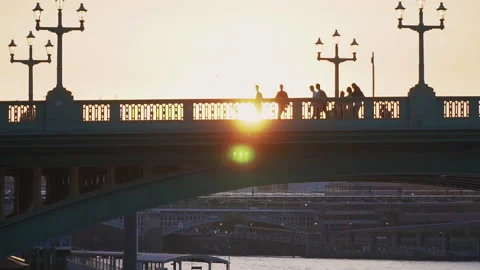 Glowing sunlight in the background people walking happy silhouettes, urban walk Stock Footage 146675505