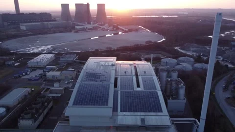 Glowing sunrise over solar panels industrial installation factory rooftop Stock Footage 171284053