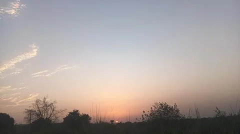 Glowing Sunset and Power Lines over Horizon Background Stock Photos