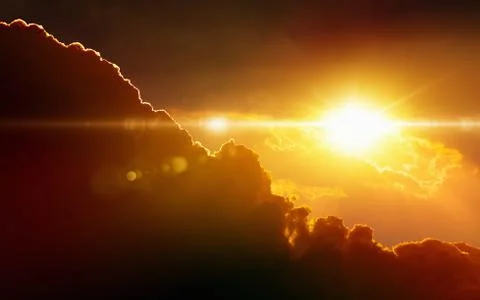 Glowing sunset, dark red clouds, bright sun rays 写真素材