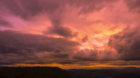 Glowing Sunset with Layered Dark Storm Clouds Timelapse Stock Footage 320812451