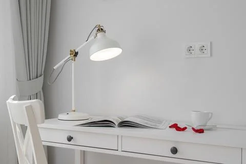 Glowing table lamp on the table Stock Photos