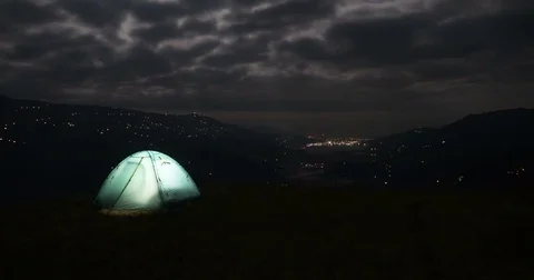 Glowing tent in the background of dark clouds Stock Footage 70469054