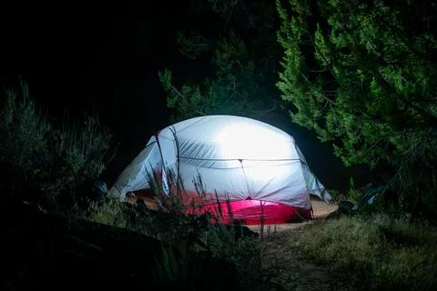 Glowing tent at night while camping Foto stock
