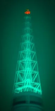 Glowing tower with teal light at night Stock Photos