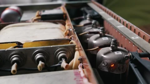 Glowing Vacuum Tubes Operating Inside a Homemade Electronic Amplifier Circuit Stock Footage 334130798