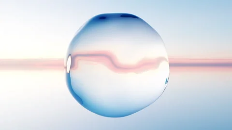 Glowing Water Sphere Floating Over Sunset Ocean Seamless Loop Stock Footage 342771761