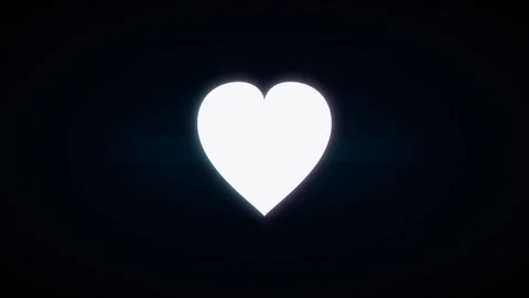 A glowing white heart shape centered on a plain black with a soft light eff.. Stock Footage 346188524