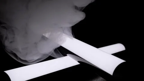 Glowing White Light Tubes Crossed with Swirling Smoke on Black Background Stock Footage 338998864