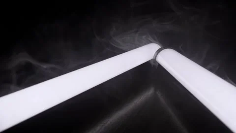Glowing White Light Tubes Surrounded by Swirling Smoke Against Black Background Stock-Footage 338998795