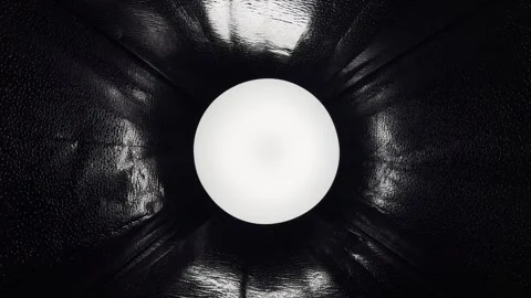 Glowing white orb illuminates mysterious converging black leather padded interio Stock Footage 330946689