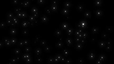 Glowing white specks fall against a black background Stock Footage 336591169