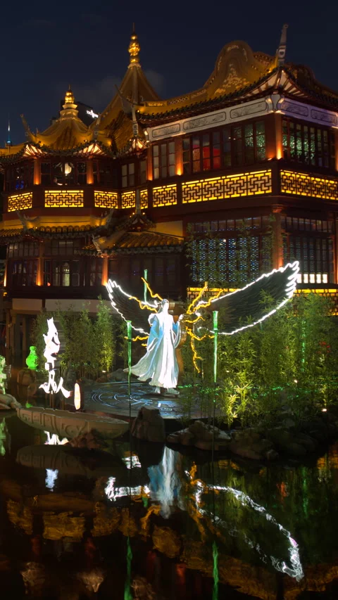 Glowing winged lantern and illuminated pagoda at night in SHANGHAI China 库存影片 344917358