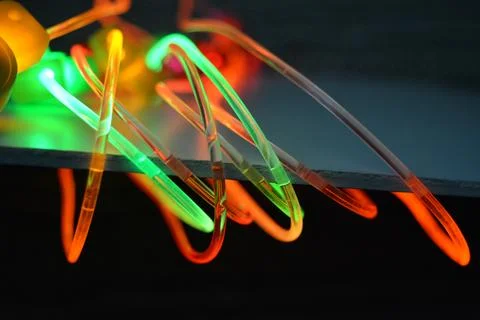 Glowing wire of red, green, yellow, orange, pink lighting are on white plastic. Stock Photos