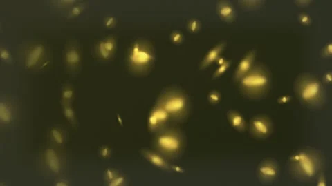 Glowing yellow particles on dark background. 2d animation 스톡 동영상 345877257