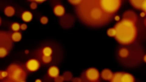 Glowing yellow particles float across a dark background Stock Illustration