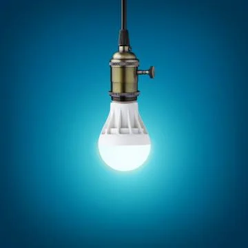 Glowinng LED bulb on blue background Stock Photos