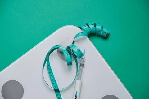 Glp-1 injection pen with measuring tape on scale Stock Photos