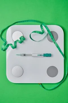 Glp-1 injection pen with scale and measuring tape Stock Photos