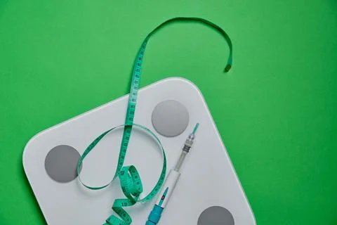 Glp-1 injection pen with scale and measuring tape Stock Photos