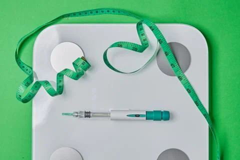 Glp-1 injection pen with scale and measuring tape Stock Photos