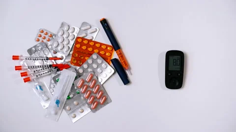 Glucometer with blood glucose meter is placed on table with medicine Stock Footage 195547777