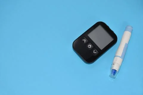 Glucometer on a blue background.	 Stock Photos