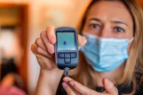 Glucometer device for glucose test with dripped blood in diabetic patients held Stock Photos
