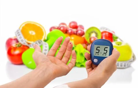 Glucometer for glucose level and healthy organic food on a white background Stockfoto's