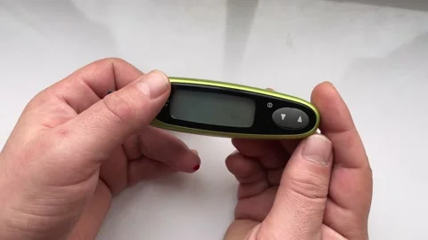 A glucometer in the hands of a man shows a high blood sugar content. The concept Stock Footage 236370438