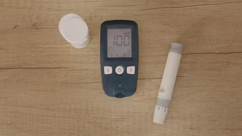 Glucometer reading shows 100 mg dL, indicating high blood sugar level Stock Footage 346703631
