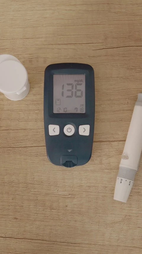 Glucometer reading shows high blood sugar level on wooden table Stock Footage 346713963