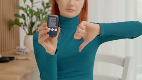 Glucometer shows high reading of 136 mg dL in health check at home Stock Footage 334033867