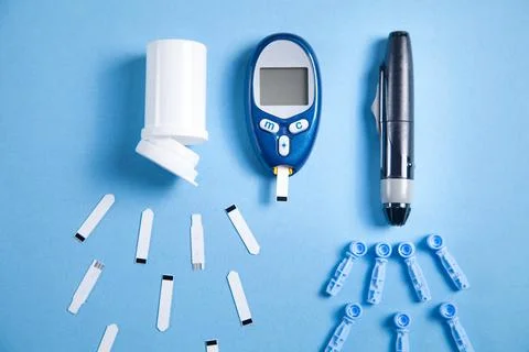 Glucometer with test strips and other objects. Devices for measuring of gluco Stock Photos