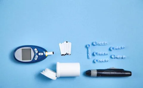 Glucometer with test strips and other objects. Devices for measuring of gluco Stock Photos
