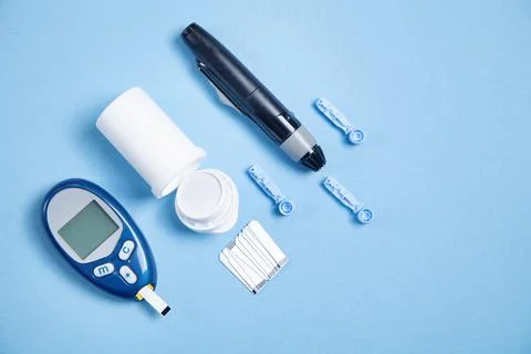 Glucometer with test strips and other objects. Devices for measuring of gluco Stock Photos