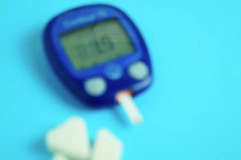 Glucometer with a very low sugar reading. Blur effect. Clouding of consciousness Stock Photos
