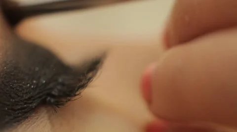 Glue and paint eyelashes Stock Footage 44440539