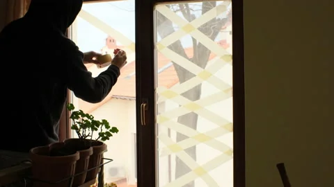 Glue tape on windows to prevent fragments from explosion during the war in ukrai Stock Footage 174852270