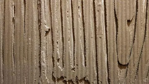 Glue for a tile with a gear pattern. Installation of tiles. The surface of th Stock Photos