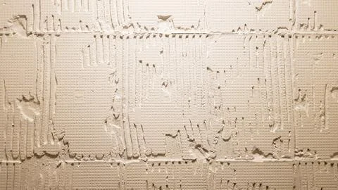 Glue for a tile with a gear pattern. Installation of tiles. The surface of th Foto stock