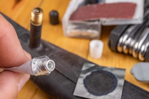 Gluing a bicycle detector in the workshop. Small works in the home garage. Stock Photos