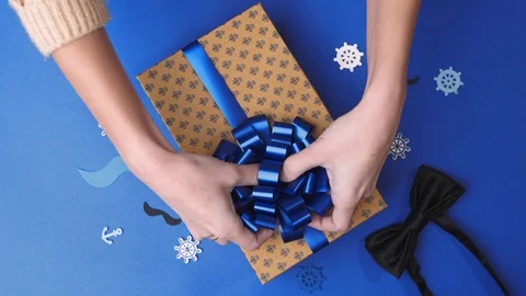 Gluing the bow to the present box for men, wrapping the present, parcel Stock Footage 102032795