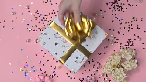 Gluing the bow to the present box, wrapping the present, parcel decoration, box Stock Footage 100962363