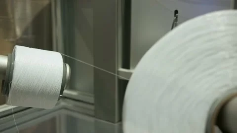 Gluing elastic thread for a tight fit to the leg. Side barriers of diapers. Stock Footage 165842412