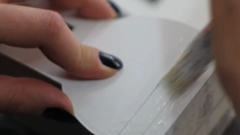 Gluing paper with a brush Stock Footage 124278427