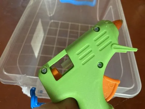 Gluing plastic containers using a gun Stock Photos