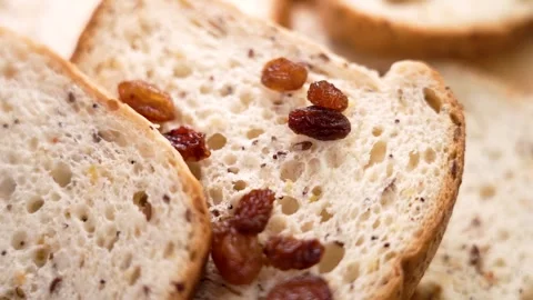 Gluten free sliced white bread with falling raisins 動画素材 250594836