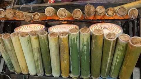 Glutinous rice roasted in bamboo joints Stock Footage 101459170