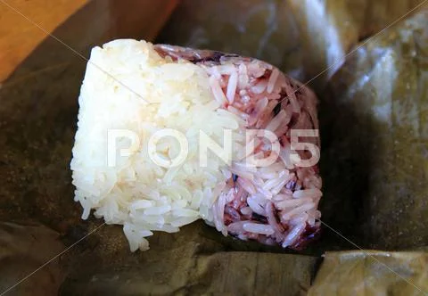 Glutinous rice wrapped in banana leaves Stock Photos